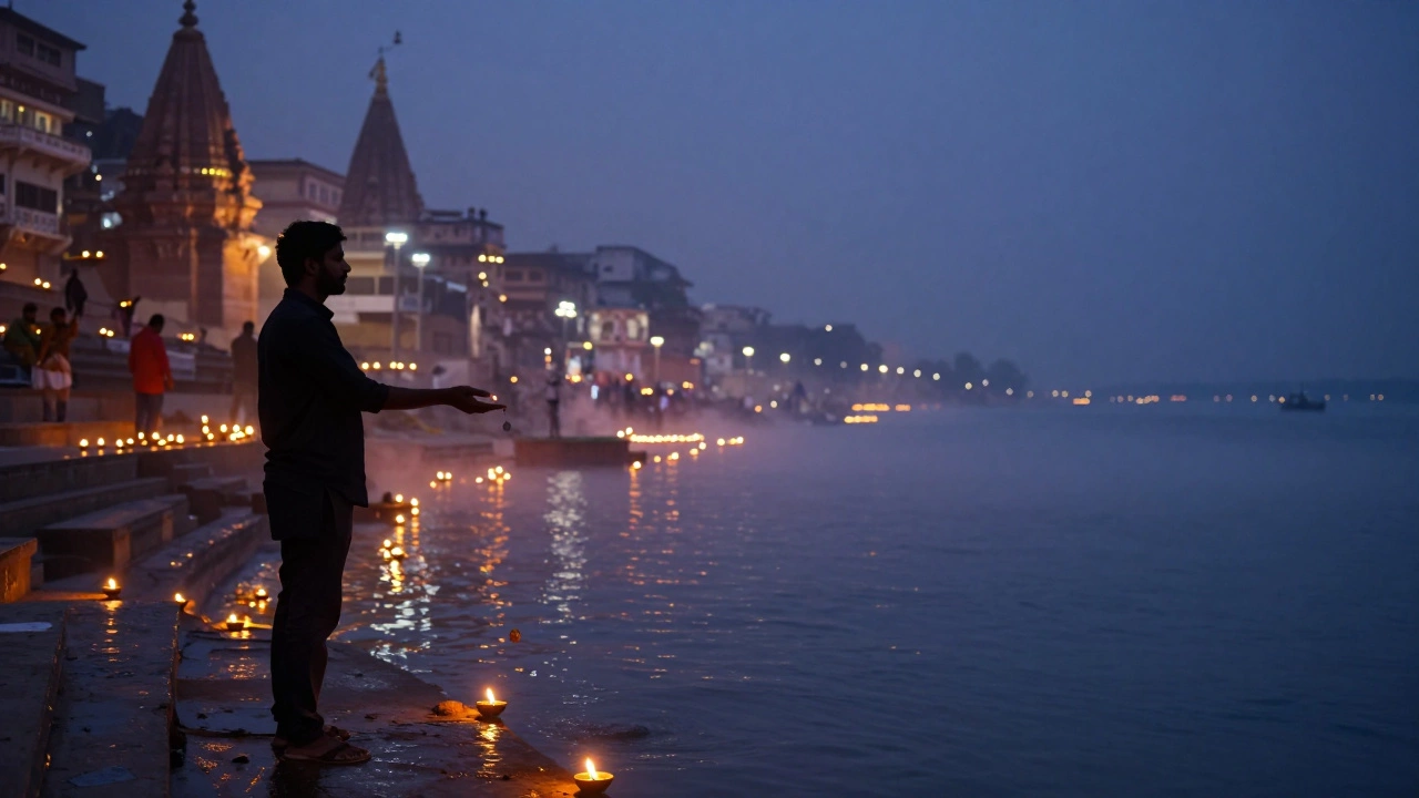Silhouetted traveler at Ganga Aarti as oil lamps float on the river at dusk.