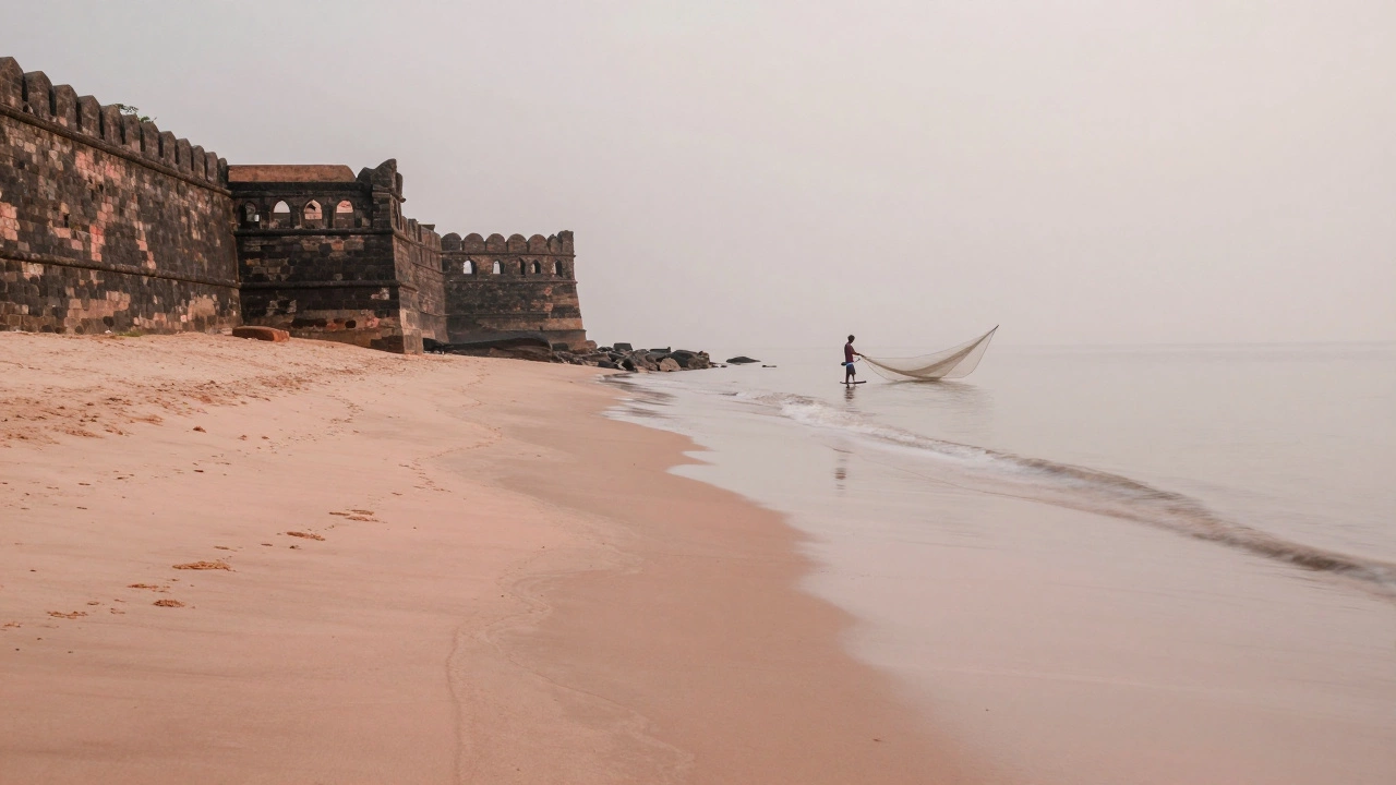 Vattakottai Fort Beach at dawn with pink sand streaks and lone fisherman mending nets.